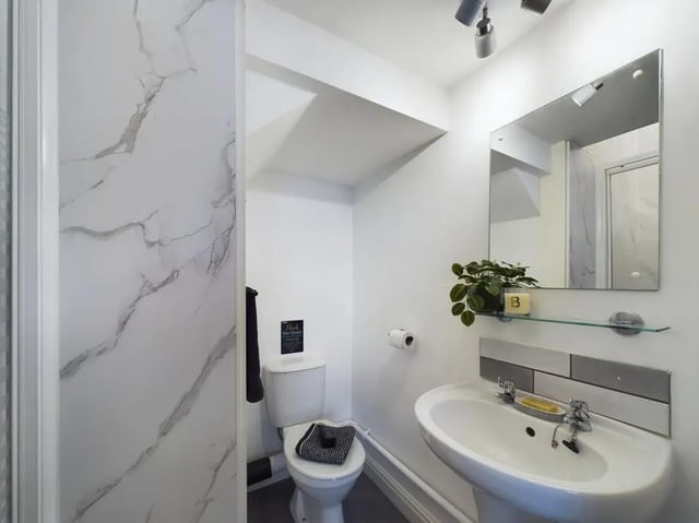 Toilet sink and marbled shower cubicle bathroom at 6 Bedroom House at 73, West Parade in Lincoln Student Accommodation