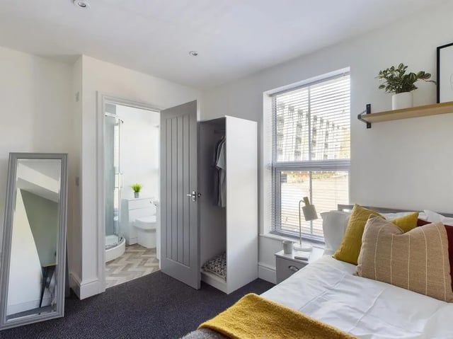 Bed with wardrobe and ensuite bathroom bedroom at 6 Bedroom House at 47, Monks Road in Lincoln Student Accommodation