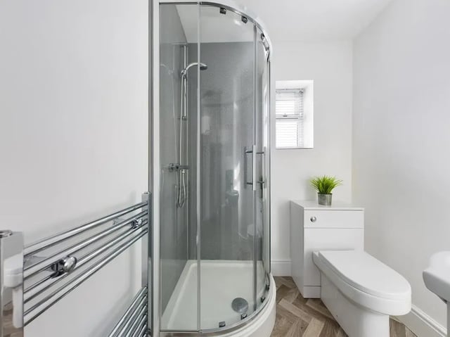 Shower unit toilet and towel radiator bathroom at 6 Bedroom House at 47, Monks Road in Lincoln Student Accommodation