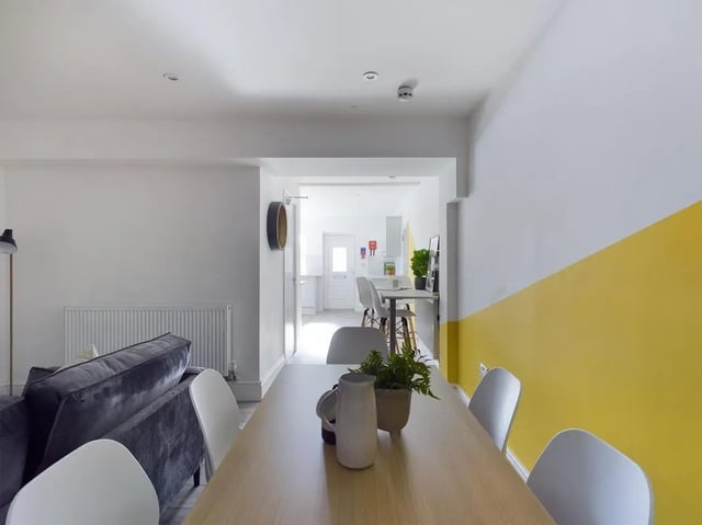 Sofa radiator dining table and chairs kitchen living room at 6 Bedroom House at 47, Monks Road in Lincoln Student Accommodation