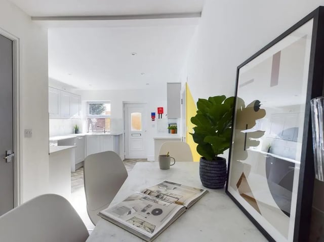 Table chairs plant framed art kitchen area at 6 Bedroom House at 47, Monks Road in Lincoln Student Accommodation