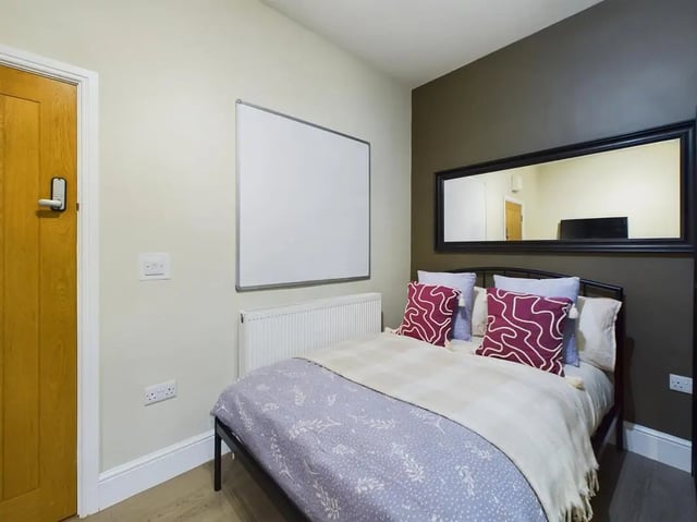 Bed with whiteboard and mirror bedroom at 7 Bedroom House at 19, Studios at, St. Catherines in Lincoln Student Accommodation