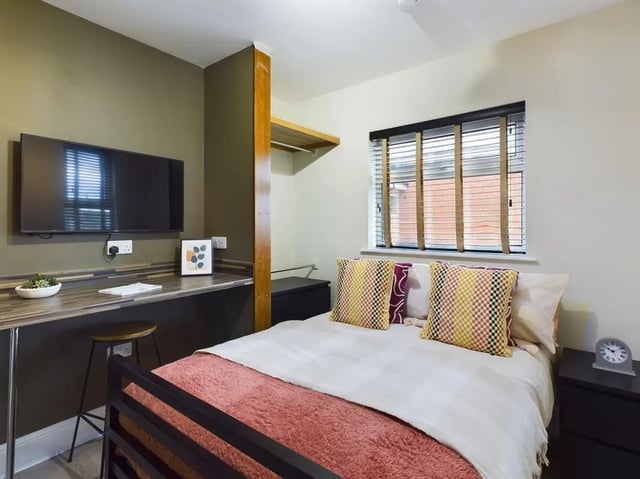 TV desk stool bed pillows and window bedroom at 7 Bedroom House at 19, Studios at, St. Catherines in Lincoln Student Accommodation