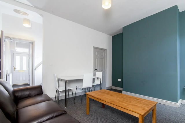 Brown sofa dining table white chairs living room at 3 Bedroom House at 8, Haddon Street in Salford Student Accommodation