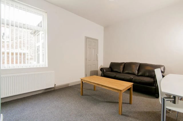 Brown leather sofa wooden table carpet living room at 3 Bedroom House at 8, Haddon Street in Salford Student Accommodation