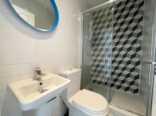 Sink toilet shower cubicle geometric tiles bathroom at 6 Bedroom House at 18, Halsbury Road in Liverpool Student Accommodation