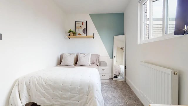 Bed dresser shelf mirror window bedroom at 6 Bedroom House at 18, Halsbury Road in Liverpool Student Accommodation