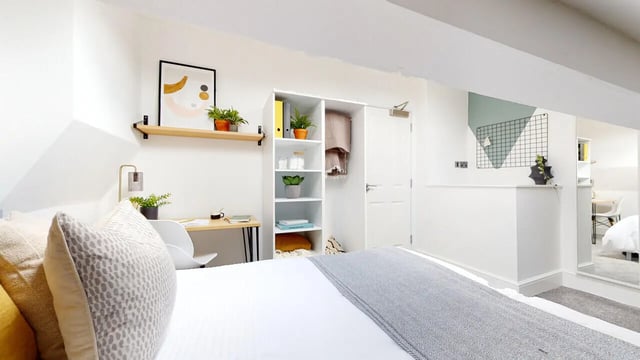 Bed desk plants shelves and door bedroom at 6 Bedroom House at 18, Halsbury Road in Liverpool Student Accommodation