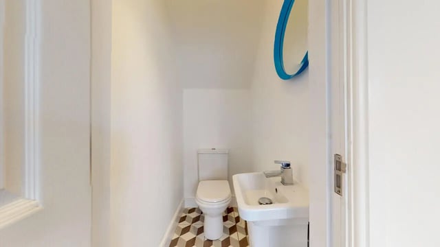 Toilet sink and blue mirror bathroom at 6 Bedroom House at 18, Halsbury Road in Liverpool Student Accommodation