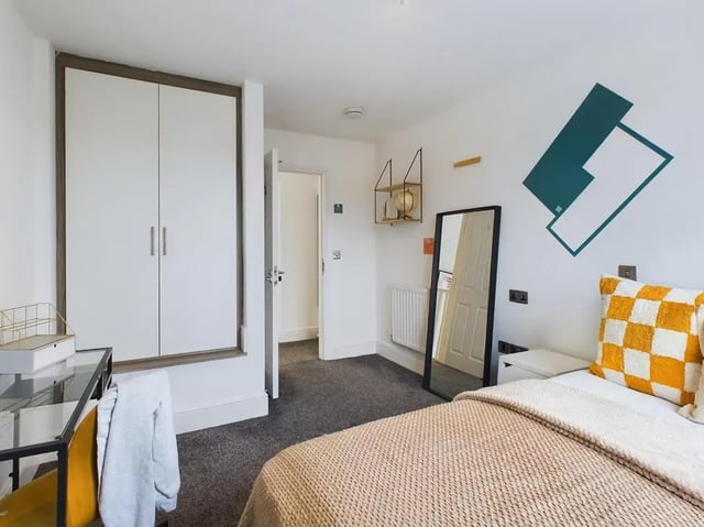 Wardrobe desk mirror bed with checkered pillow bedroom at 4 Bedroom House at Flat 5, 265, Edge Lane in Liverpool Student Accommodation