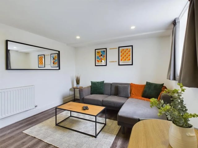 Grey sectional sofa coffee table artwork living room at 4 Bedroom House at Flat 5, 265, Edge Lane in Liverpool Student Accommodation