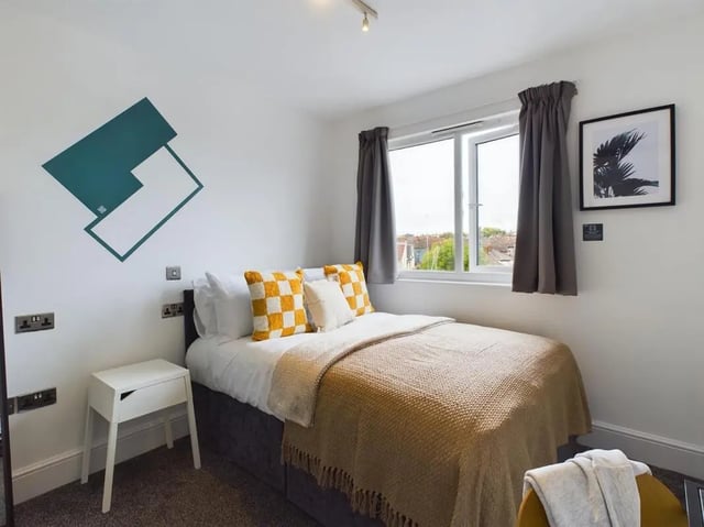 Bed white bedside table yellow pillows bedroom at 4 Bedroom House at Flat 5, 265, Edge Lane in Liverpool Student Accommodation