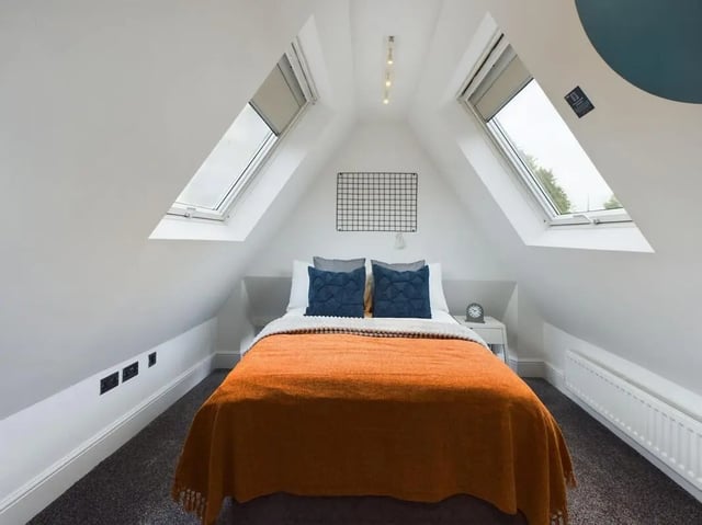 Bed with orange throw two blue pillows bedroom at 4 Bedroom House at Flat 5, 265, Edge Lane in Liverpool Student Accommodation