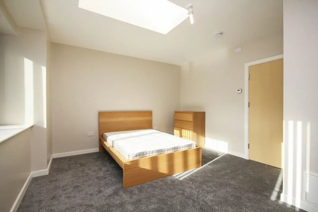 Wooden bed dresser door and window bedroom at 7 Bedroom House at 4, Well Meadow Drive in Sheffield Student Accommodation