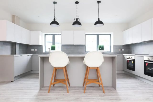 Modern kitchen with island and two white stools kitchen at 7 Bedroom House at 8, Well Meadow Drive in Sheffield Student Accommodation