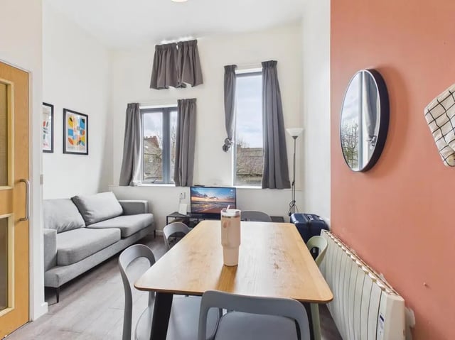Sofa table chairs television and radiator living room at 3 Bedroom House at Flat 3, 18, China Street in Lancaster Student Accommodation
