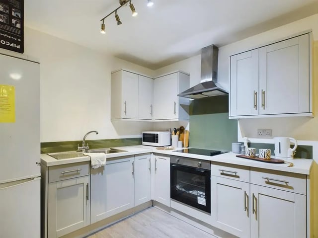 Refrigerator sink microwave oven and cabinets kitchen at 3 Bedroom House at Flat 3, 18, China Street in Lancaster Student Accommodation
