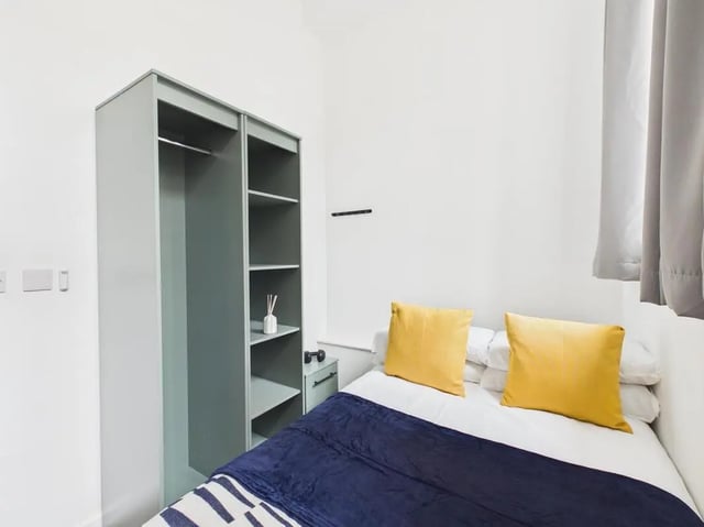 Wardrobe bed with yellow pillows bedroom at 3 Bedroom House at Flat 3, 18, China Street in Lancaster Student Accommodation