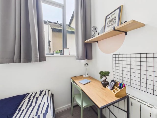 Desk chair lamp shelf and bed study area at 3 Bedroom House at Flat 3, 18, China Street in Lancaster Student Accommodation