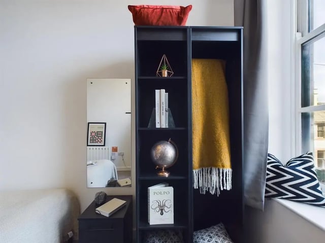 Books globe yellow blanket in black shelf bedroom at 5 Bedroom House at Flat 4, 18, China Street in Lancaster Student Accommodation