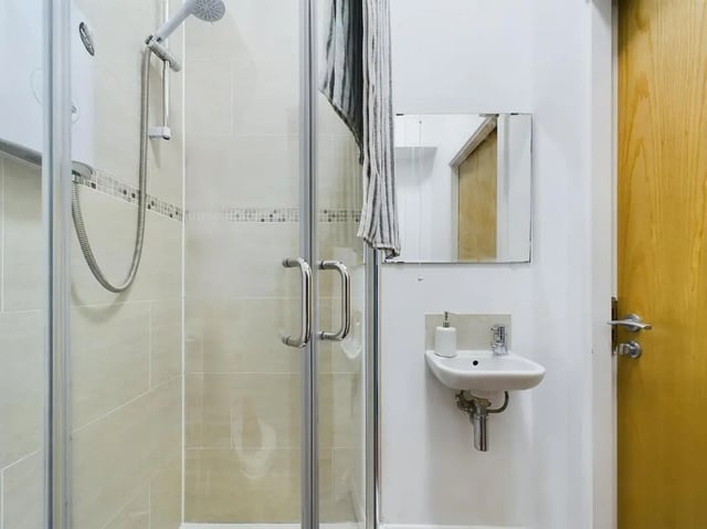 Shower enclosure sink mirror towel and door bathroom at 5 Bedroom House at Flat 4, 18, China Street in Lancaster Student Accommodation