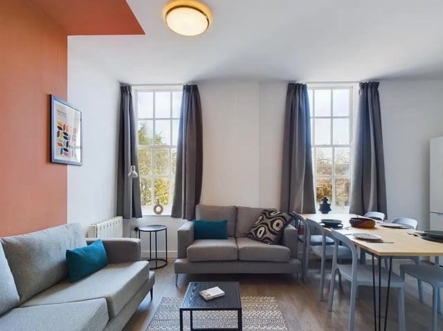 Two sofas dining table and chairs living room at 5 Bedroom House at Flat 4, 18, China Street in Lancaster Student Accommodation