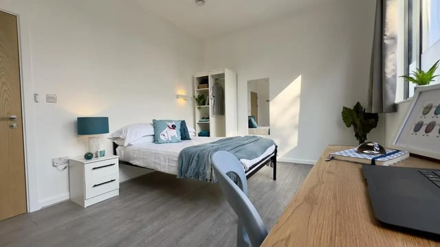 Bed with dog pillow wardrobe mirror desk bedroom at 4 Bedroom House at Flat 8, 18, China Street in Lancaster Student Accommodation