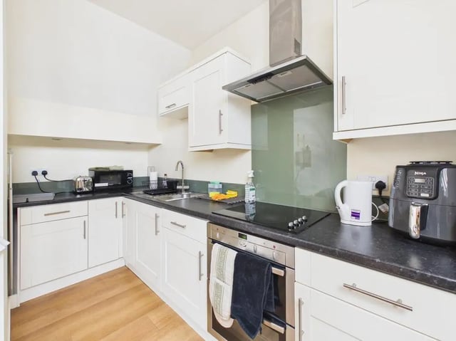 White cabinets sink microwave kettle air fryer kitchen at 4 Bedroom House at Flat 9, 18, China Street in Lancaster Student Accommodation