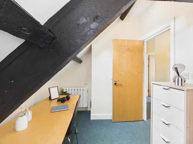 Desk with headphones and wooden beams study area at 4 Bedroom House at Flat 9, 18, China Street in Lancaster Student Accommodation