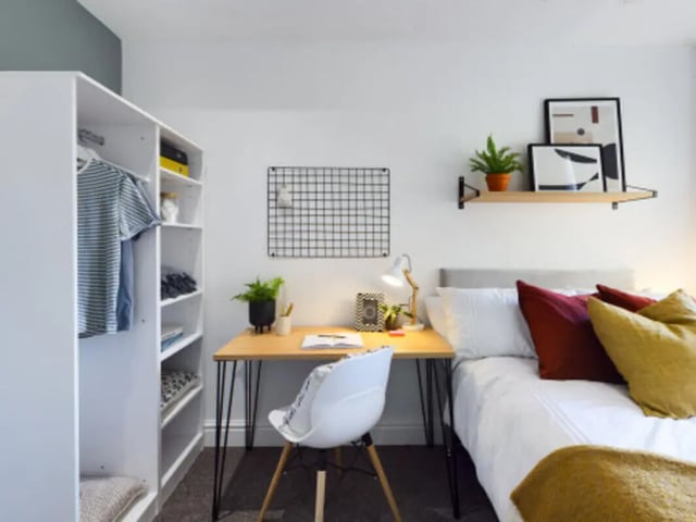 Wardrobe desk bed pillows and framed art bedroom at 9 Bedroom House at 128, Uttoxeter New Road in Derby Student Accommodation