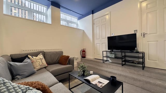 Grey sofa television and coffee table living room at 6 Bedroom House at 19C, Bower Road in Sheffield Student Accommodation