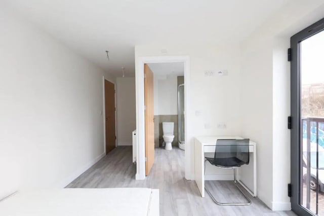 White desk and chair with toilet and shower at 17 Bedroom House at 10, Ashton Studios, Well Meadow Drive in Sheffield Student Accommodation