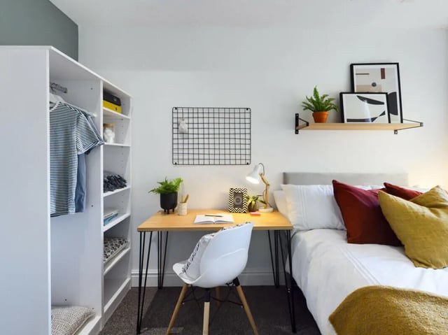 Wardrobe desk chair bed with pillows bedroom at 4 Bedroom House at 7, Westbourne Grove in Lincoln Student Accommodation