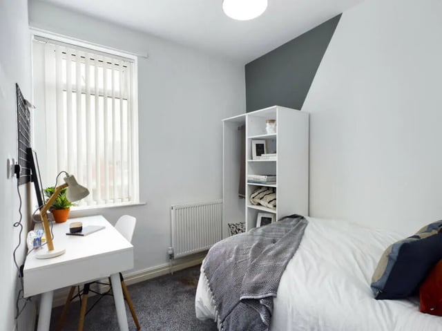 Bed desk lamp shelf window and radiator bedroom at 6 Bedroom House at 36, Brae Street in Liverpool Student Accommodation