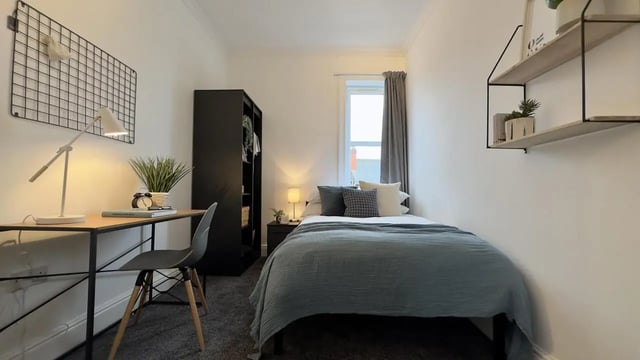 Bed desk lamp closet shelves bedroom at 6 Bedroom House at 214, West Parade in Lincoln Student Accommodation