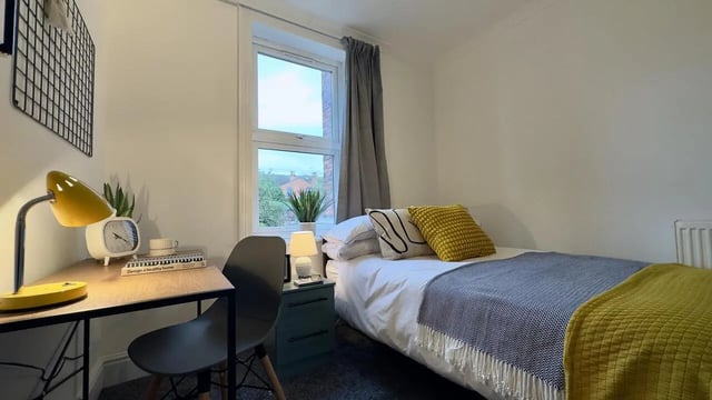 Desk lamp bed rug bedside table bedroom at 6 Bedroom House at 214, West Parade in Lincoln Student Accommodation