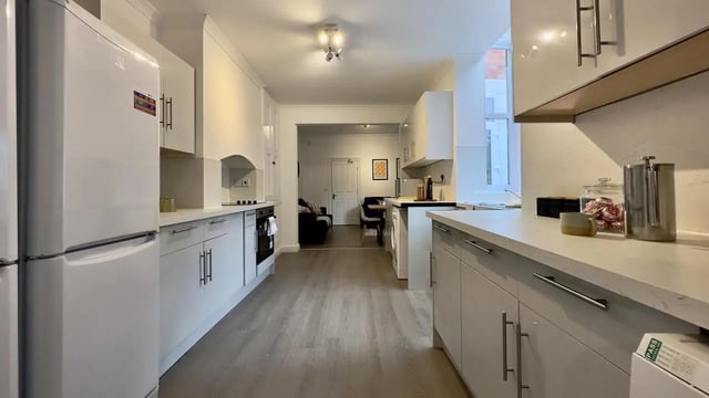 White refrigerator modern cabinets countertop kitchen appliances kitchen at 6 Bedroom House at 214, West Parade in Lincoln Student Accommodation