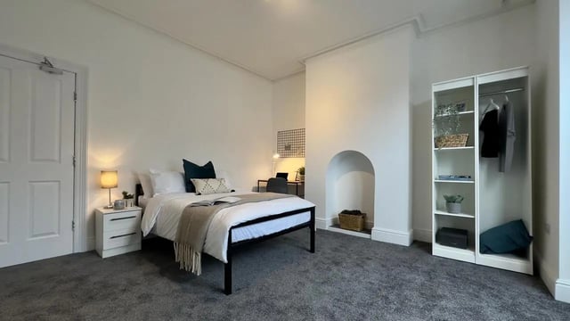 Bed nightstand wardrobe desk fireplace bedroom at 6 Bedroom House at 214, West Parade in Lincoln Student Accommodation