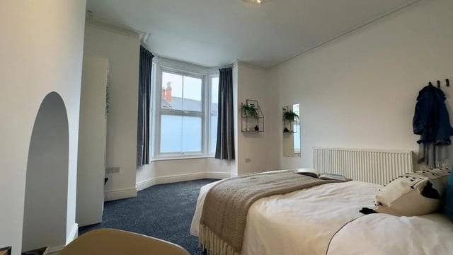Bed with blanket and pillows window bedroom at 6 Bedroom House at 214, West Parade in Lincoln Student Accommodation