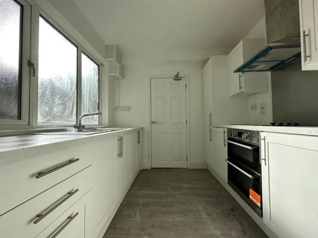 White cabinets sink faucet oven and door kitchen at 6 Bedroom House at 6, Milking Stile Lane in Lancaster Student Accommodation