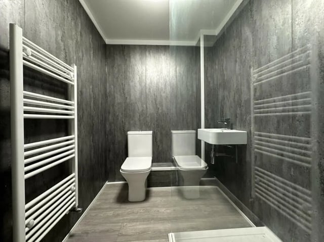 Two toilets sink and towel rails bathroom at 6 Bedroom House at 6, Milking Stile Lane in Lancaster Student Accommodation