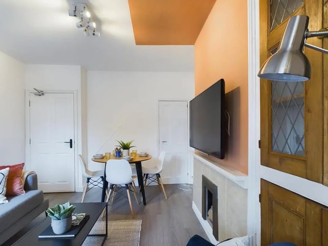 Dining table chairs television living area at 4 Bedroom House at 11, Charles Street West in Lincoln Student Accommodation