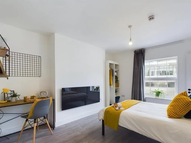 Desk bed wardrobe with yellow accents bedroom at 8 Bedroom House at 69, Monks Road in Lincoln Student Accommodation