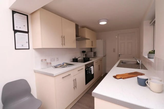 Cream cabinets sink stove and chairs kitchen at 5 Bedroom House at 43, Thesiger Street in Lincoln Student Accommodation
