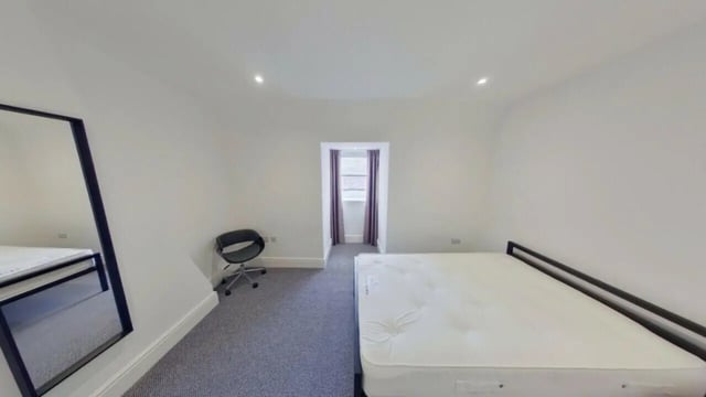 Bed chair mirror and window bedroom at 2 Bedroom House at 20 A, Portland Street in Lincoln Student Accommodation