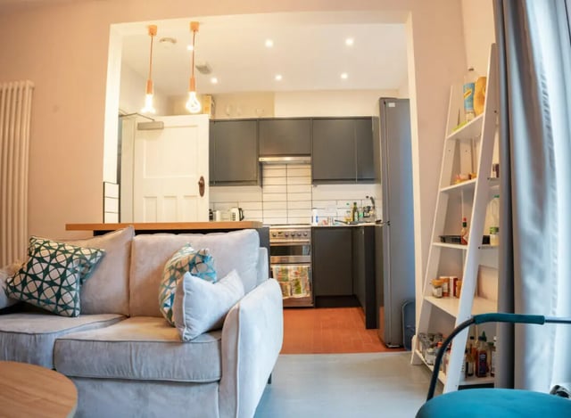 Sofa kitchen appliances and shelving unit living area at 4 Bedroom House at 16, Kelsey Street in Lancaster Student Accommodation