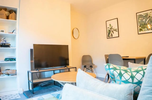 TV shelf table chairs art living room at 4 Bedroom House at 16, Kelsey Street in Lancaster Student Accommodation
