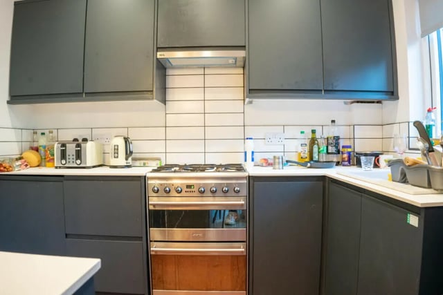 Modern kitchen with grey cabinets stove and appliances kitchen at 4 Bedroom House at 16, Kelsey Street in Lancaster Student Accommodation