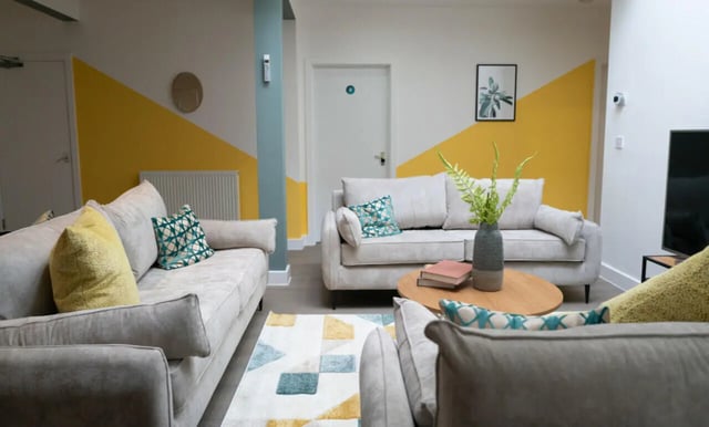 Sofas pillows coffee table geometric rug living room at 3 Bedroom House at Flat 2, 331, Dickenson Road in Manchester Student Accommodation