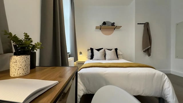 Bed with pillows throw and desk bedroom at 3 Bedroom House at 25, Romney Street in Salford Student Accommodation